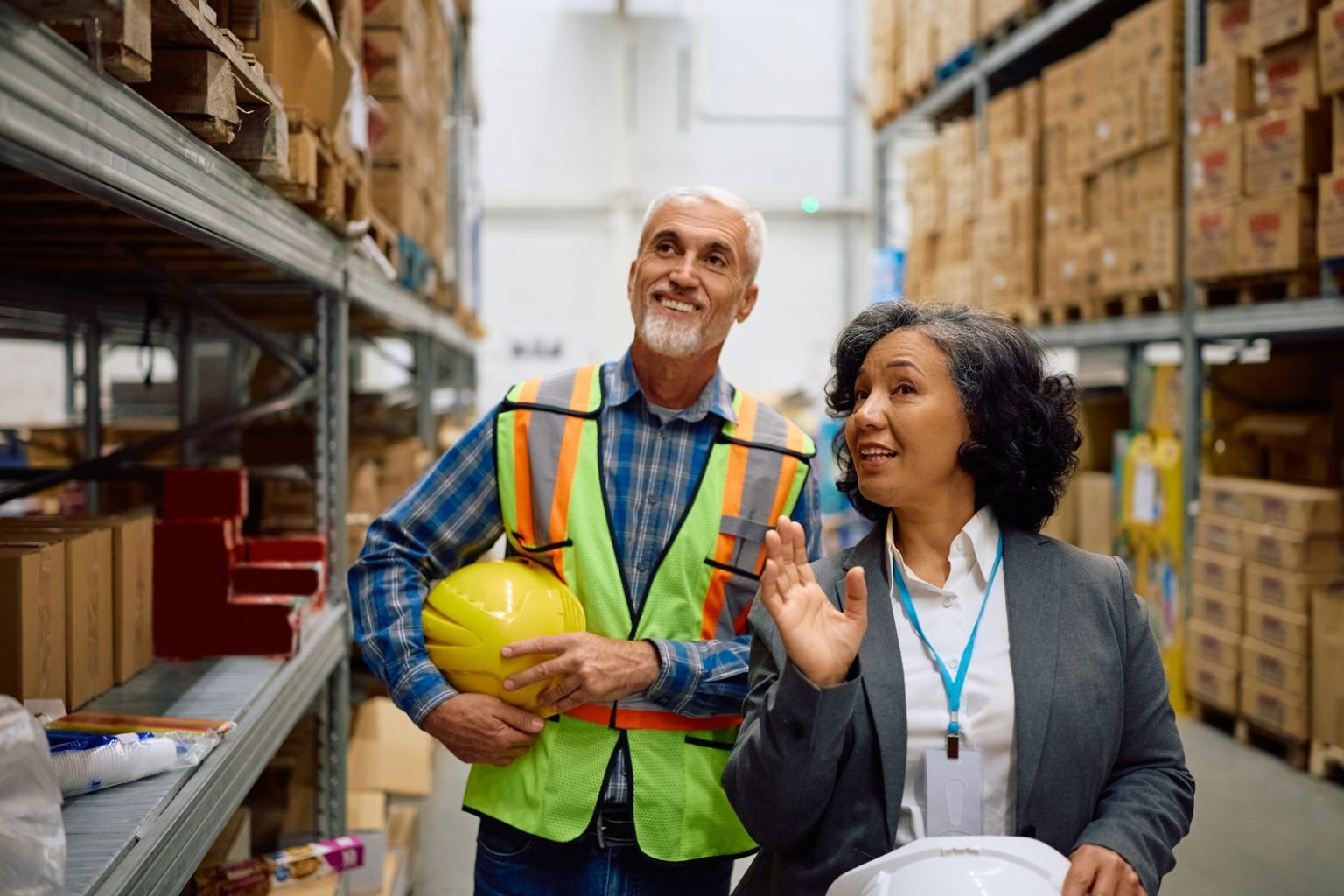 Plant leadership reviewing output on a bright production floor — Stratdel manufacturing and industrial consulting in Houston